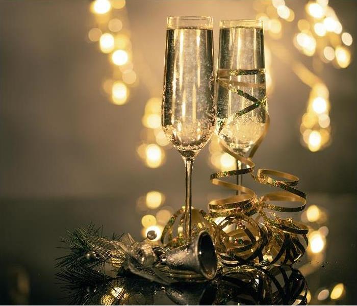 two champagne glasses surrounded by New Year's decorations